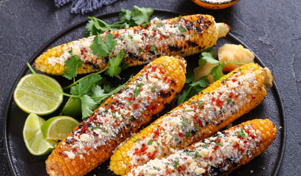 elote-grilled-mexican-street-corn-charred-cobs-are-slathered-in-sour-picture-id1335910123.jpg